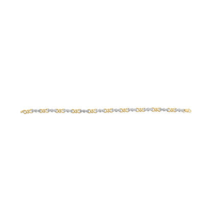 Yellow bracelet with alternating round white gemstones in miracle settings and yellow X-shaped links, shown in a flat lay horizontal angle.