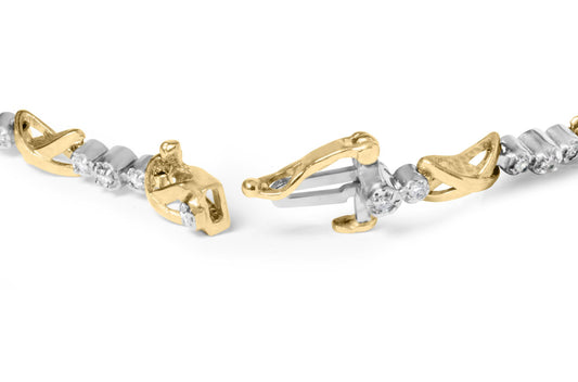 Close-up angle of a yellow and white metal bracelet with round white gemstones in prong settings, showing the clasp open.