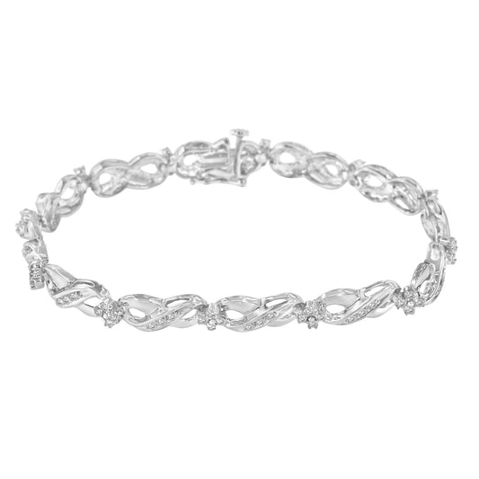 Top-down view of a white metal bracelet with intertwined links, each adorned with small white gemstones in prong settings.