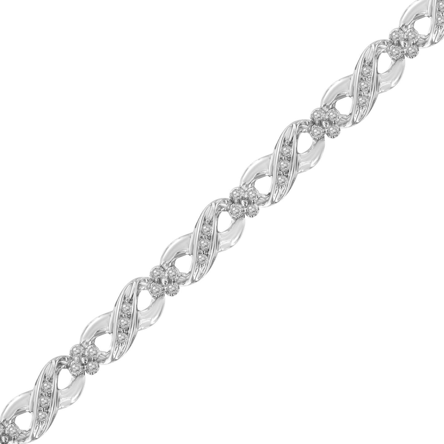 Diagonal close-up of a white metal bracelet featuring round white gemstones in prong settings arranged in twisted links and floral clusters.