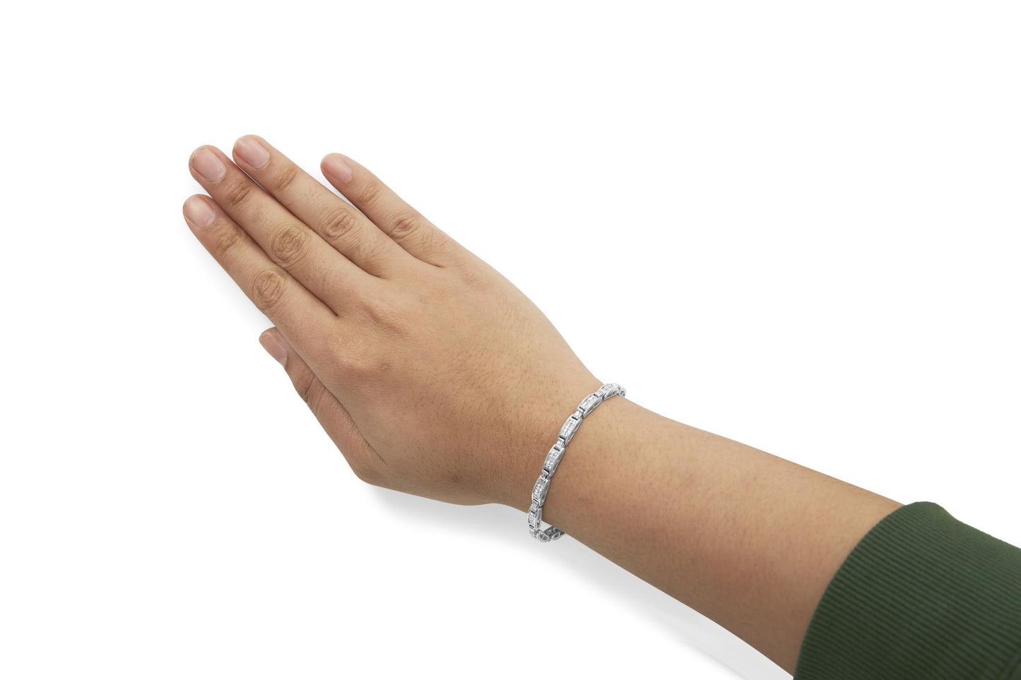 Close-up side angle of a white metal bracelet with white baguette and princess shape gemstones, worn on a model's wrist.