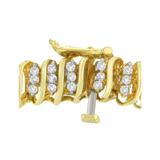 Close-up side angle of yellow metal bracelet section with round white gemstones in prong settings.