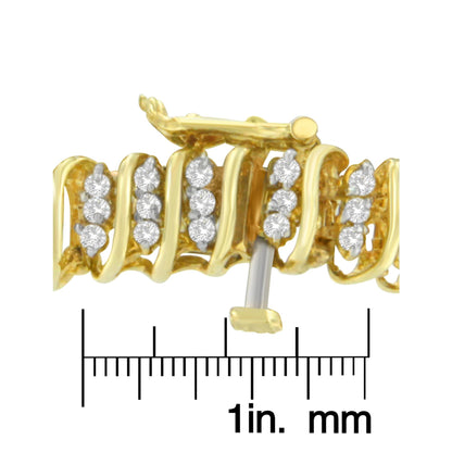 Close-up side angle of a yellow metal bracelet with multiple round white gemstones in prong settings, shown on a ruler for size reference.
