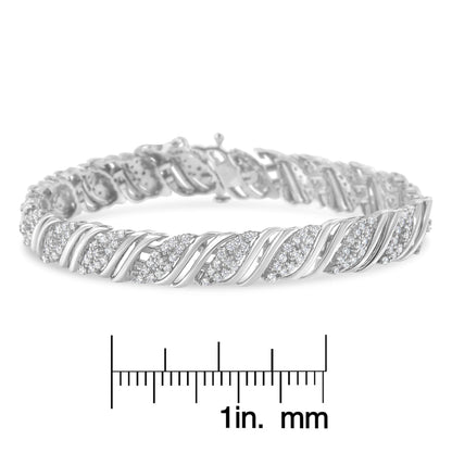 White metal bracelet with twisted design and round white gemstones, shown from an angled side view, placed above a ruler for size reference.