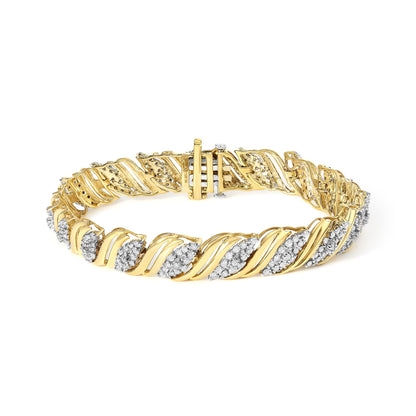 Close-up front angle of a yellow metal bracelet with curved links, accented with numerous small white gemstones in prong settings along the pattern, shown against a white background.