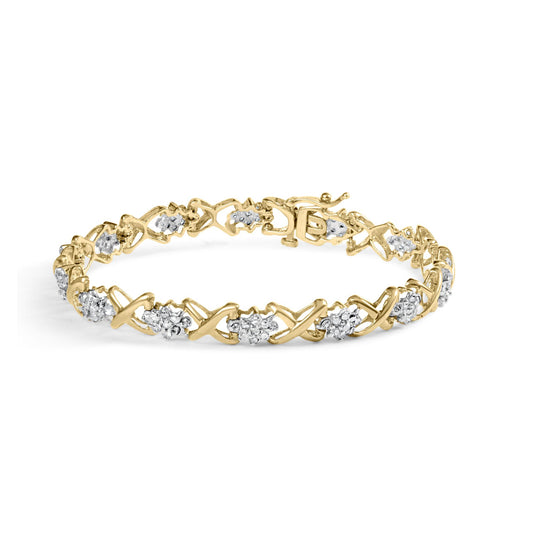 Yellow metal bracelet featuring alternating X-shaped links and clusters of round white gemstones in prong settings, shown in a close-up angled side view.