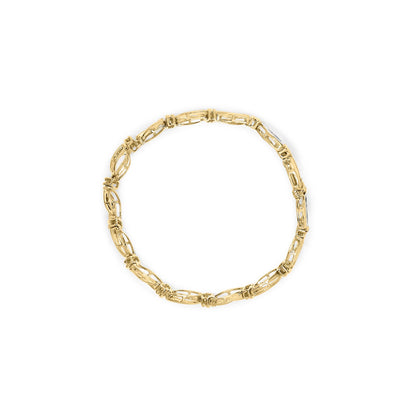 Top-down view of a yellow and white metal bracelet with alternating linked segments and white gemstones in channel settings.
