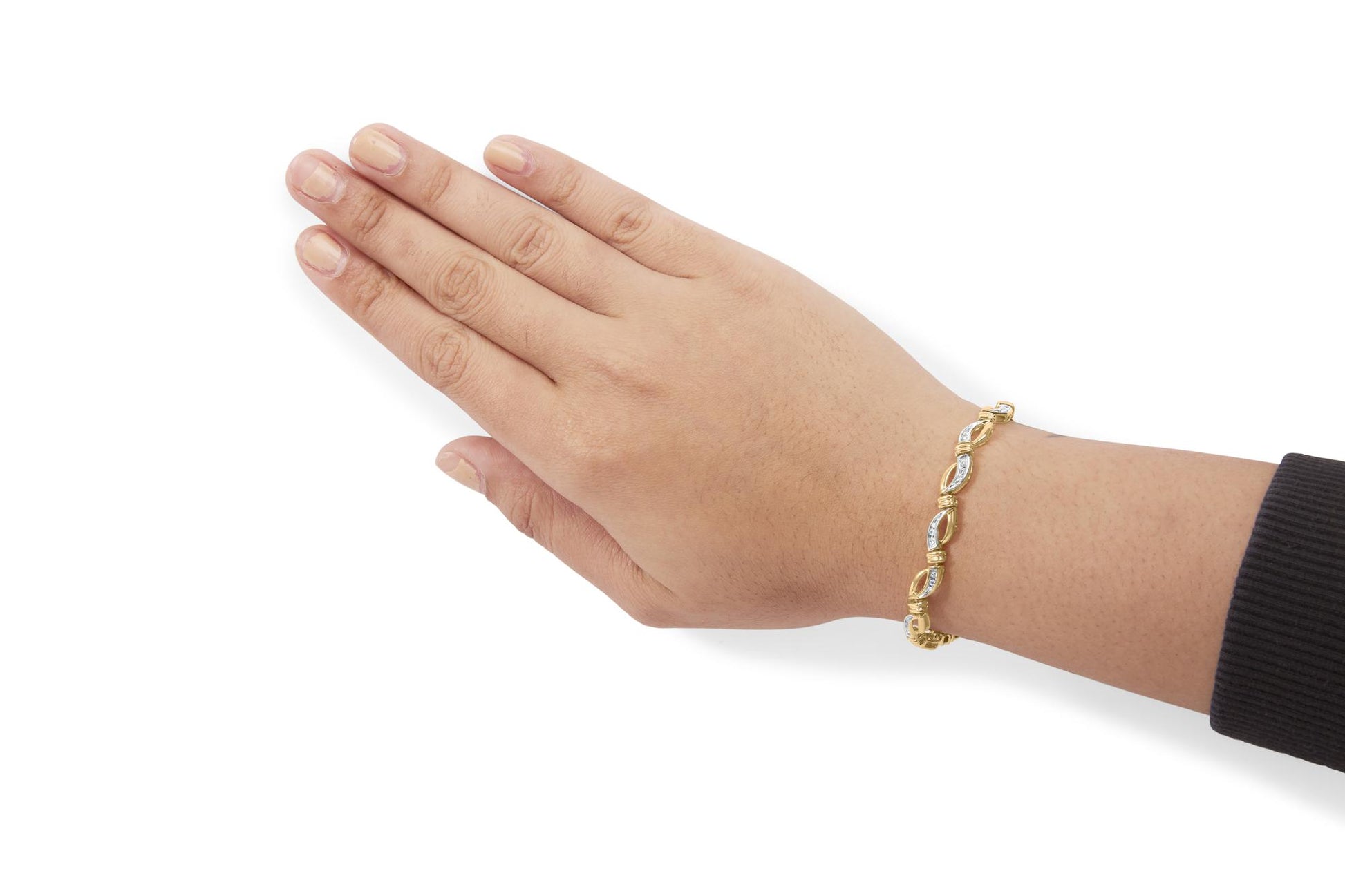 Close-up side angle of a yellow and white metal bracelet with round white gemstones in channel setting, worn on a model's wrist.