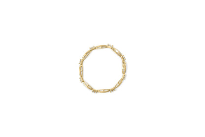 Top-down view of a yellow metal bracelet featuring alternating links with white baguette shape gemstones in channel settings and white princess shape gemstones in invisible settings.