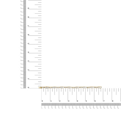 Yellow metal bracelet with alternating baguette and princess shape white gemstones, shown lying flat on intersecting rulers for size reference, top-down angle.