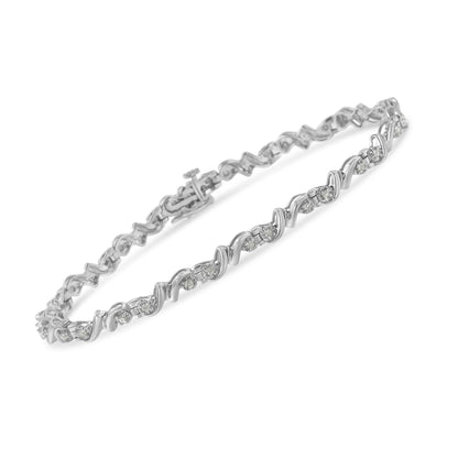 White metal bracelet with round white gemstones in a wavy setting, shown at an angle on a white background.