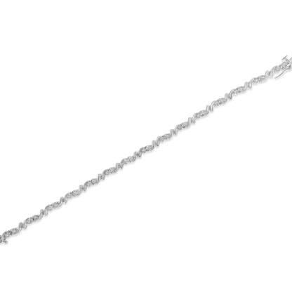 Diagonal top-down view of a white metal bracelet featuring alternating sections of twisted links and clusters of round white gemstones in a miracle setting.