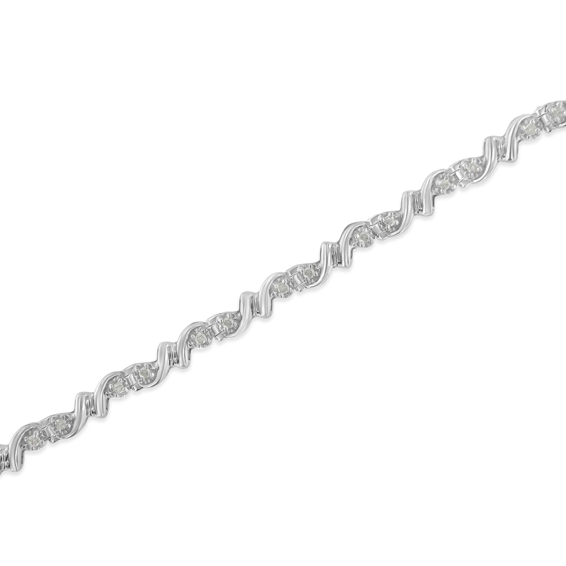Close-up image of a white metal bracelet with a wavy design, featuring round white gemstones in a miracle setting, shown at a slight angle.