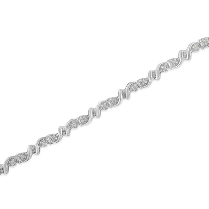 Close-up image of a white metal bracelet with a wavy design, featuring round white gemstones in a miracle setting, shown at a slight angle.