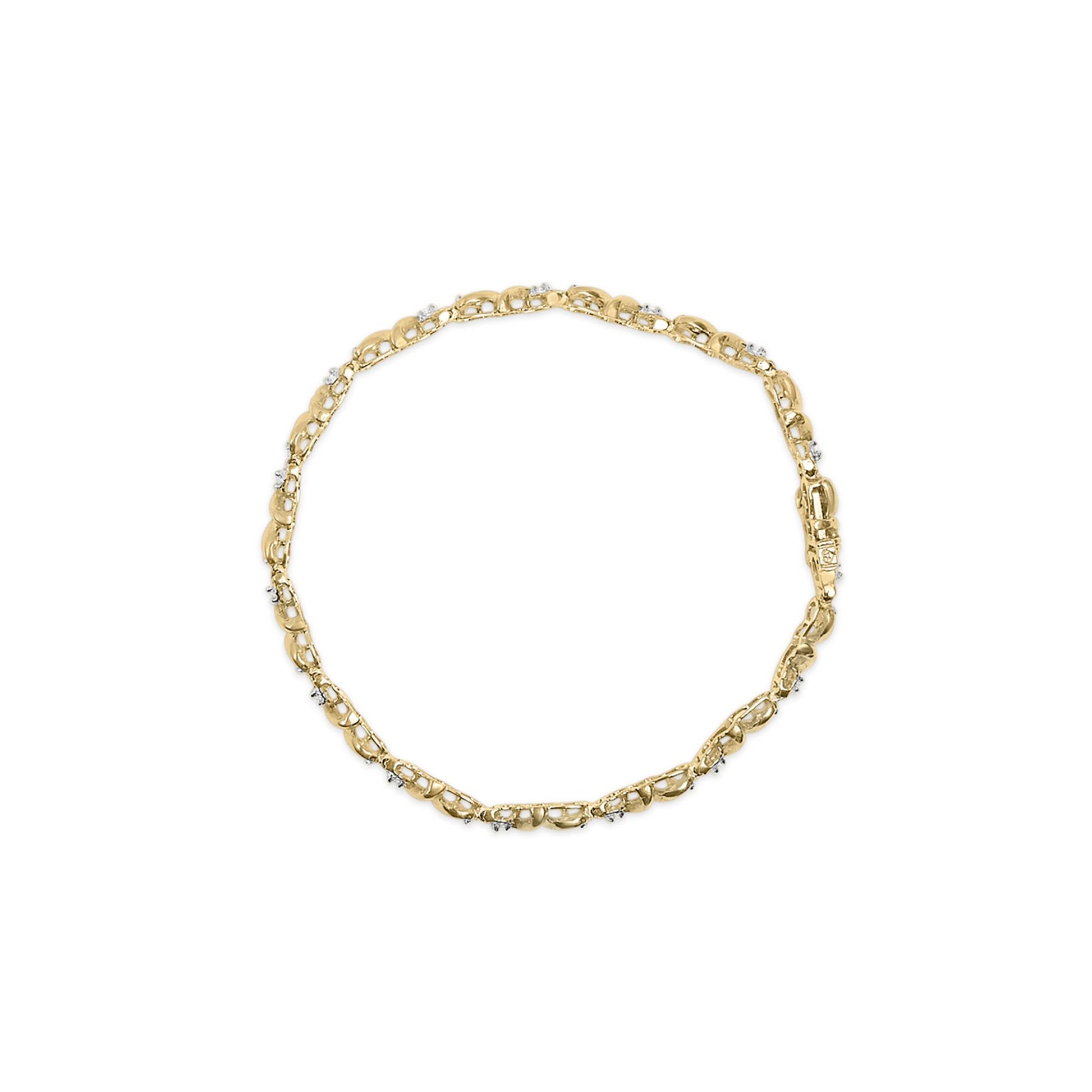 Top-down view of a yellow metal bracelet with round white gemstones set in a miracle setting along the links, displayed on a white background.