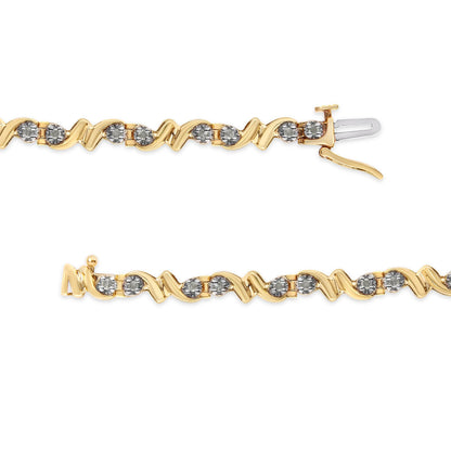 Close-up top-down view of a yellow metal bracelet with a wavy design adorned with round white gemstones set in a miracle setting, shown unclasped and laid flat.