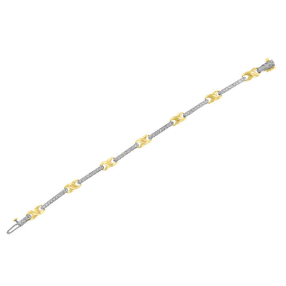 Straight angled shot of a yellow bracelet featuring alternating curved links and bars set with round white gemstones in prong settings.