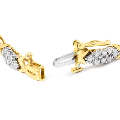 Close-up angled view of a yellow metal bracelet clasp with round white gemstones in prong settings.