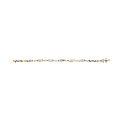 Yellow metal bracelet with alternating twisted links and oval-shaped sections set with clusters of white gemstones, shown in a top-down flat lay view.
