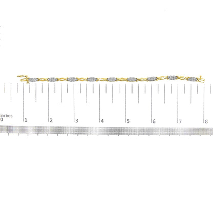 Yellow bracelet with alternating curved links and clusters of round white gemstones in prong settings, shown flat on a ruler for size reference, viewed from above.