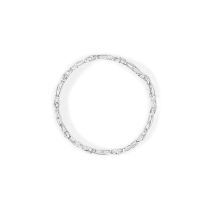 Top-down view of a white metal bracelet with princess-shaped white gemstones in an invisible setting forming a circular link design.