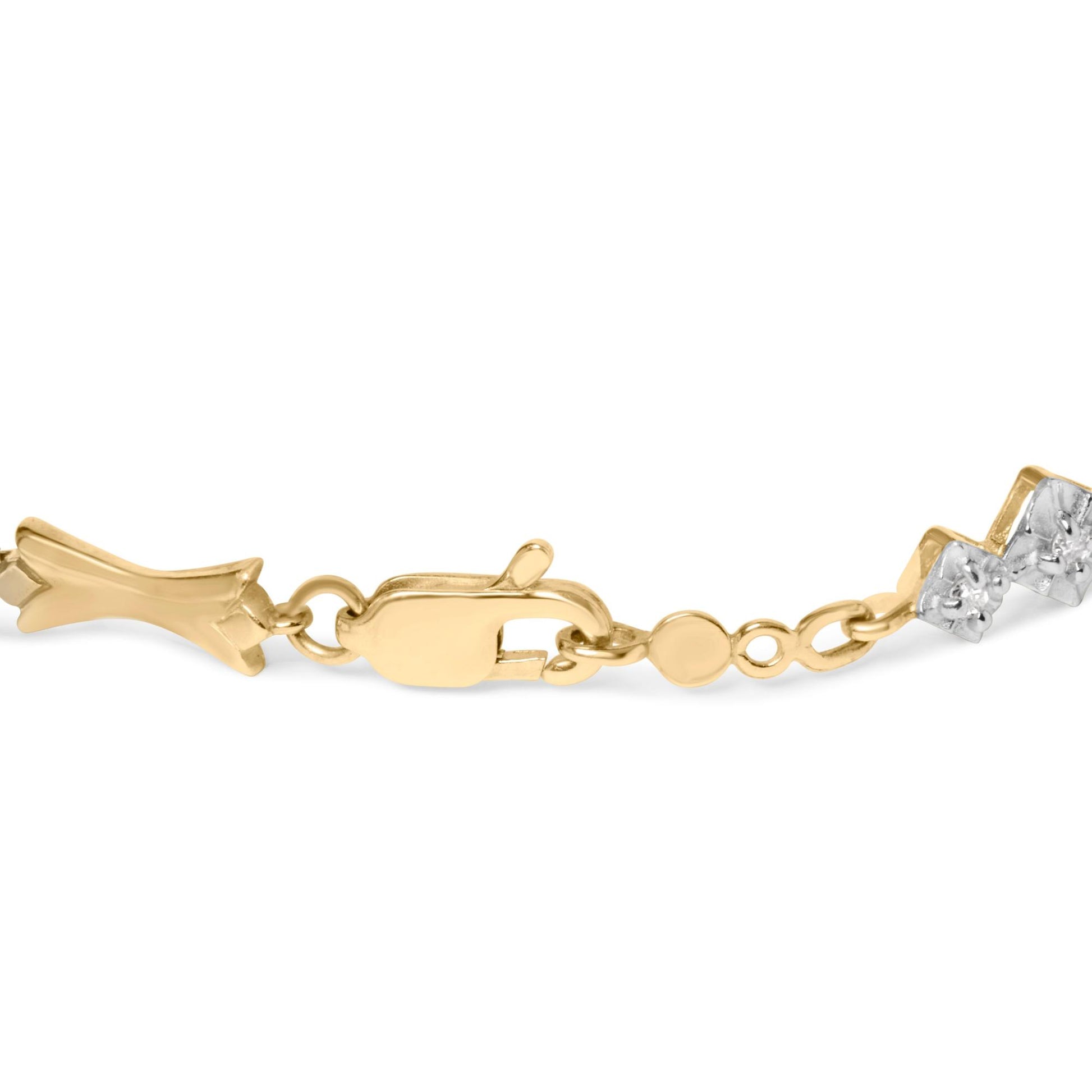 Close-up side angle of a yellow and white metal bracelet clasp featuring round white gemstones in a miracle setting.