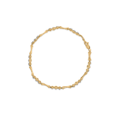 Top-down view of a bracelet with alternating yellow and white metal sections, accented with small white round gemstones set in a miracle setting.