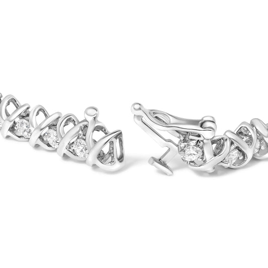 Close-up front angle of a white metal bracelet featuring round white gemstones in a 2-prong setting. The bracelet is shown unclasped.