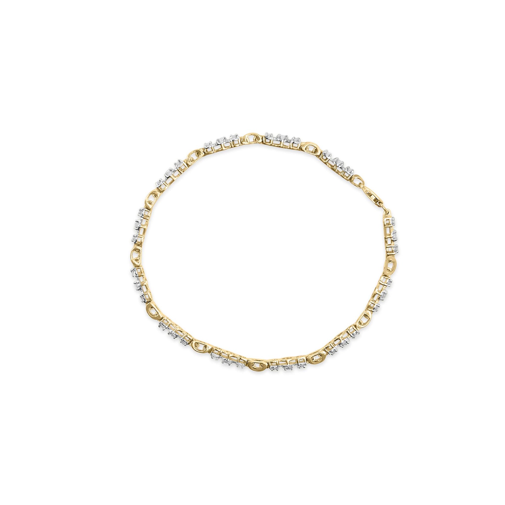 Top view of a yellow and white metal bracelet with round white gemstones in prong settings arranged along the band.