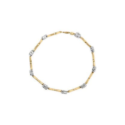 Top-down view of a yellow and white bracelet with alternating smooth yellow links and white segments set with round white gemstones.