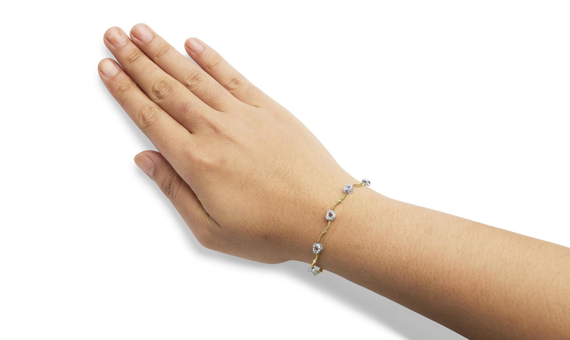 Bracelet with alternating yellow and white metal connected by links and decorated with prong-set white round gemstones, shown on a model's wrist from an angled top view.