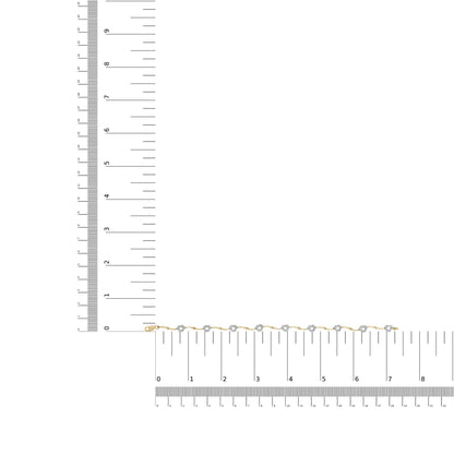 Bracelet with alternating yellow and white metal links, featuring round white gemstones in prong settings, displayed flat on a ruler for size reference, top-down view.