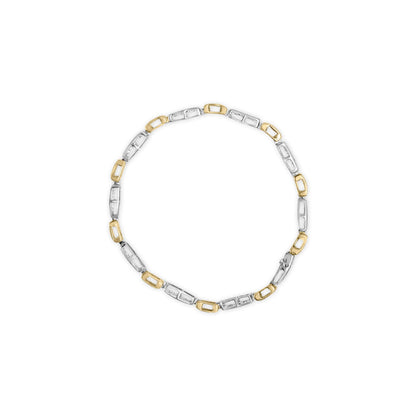 Top-down view of a two-toned bracelet with alternating rectangular links, some set with white princess-shape gemstones in invisible settings.