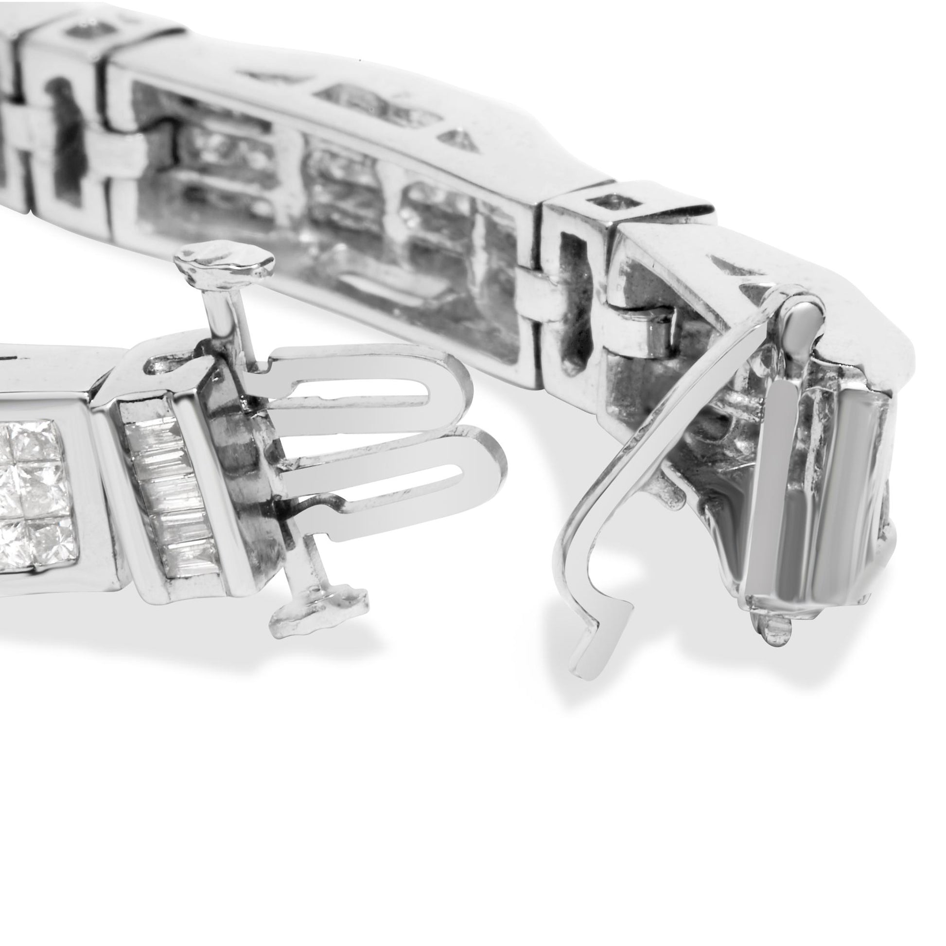 Close-up front angle of white metal bracelet clasp showing baguette and princess shaped white gemstones in channel and invisible settings.
