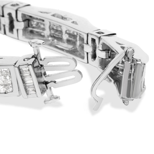 Close-up front angle of white metal bracelet clasp showing baguette and princess shaped white gemstones in channel and invisible settings.