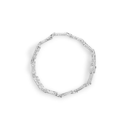 Top-down view of a white metal bracelet with linked rectangular segments, some featuring pave-set round white gemstones.
