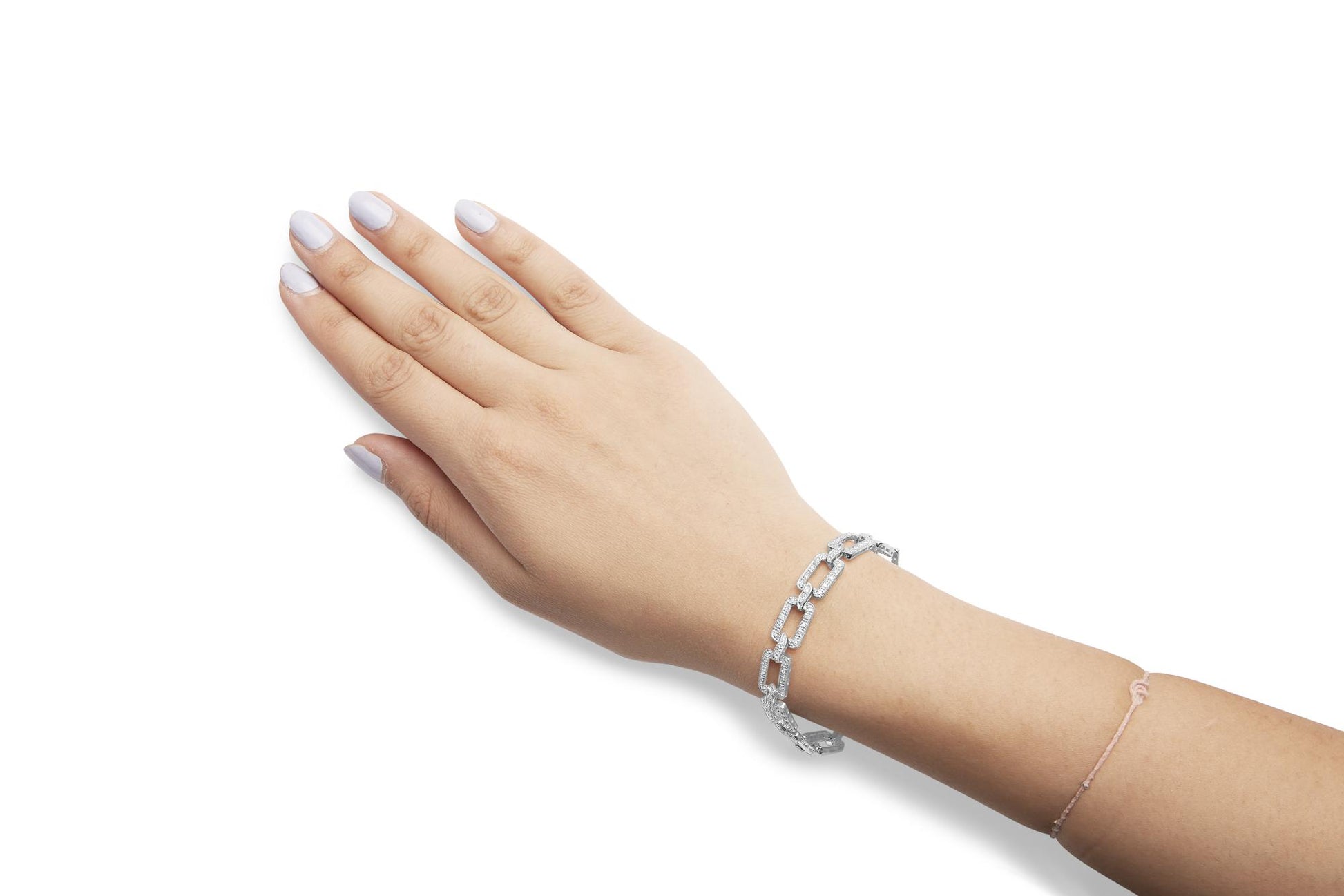 White metal bracelet with rectangular links set with white gemstones, shown on a model's wrist from a top angle.