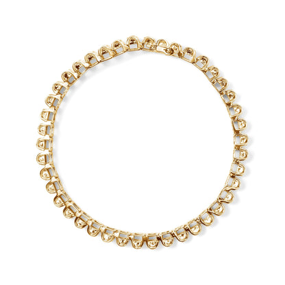 Top-down view of a yellow metal bracelet set with white princess-shaped gemstones in an invisible setting.