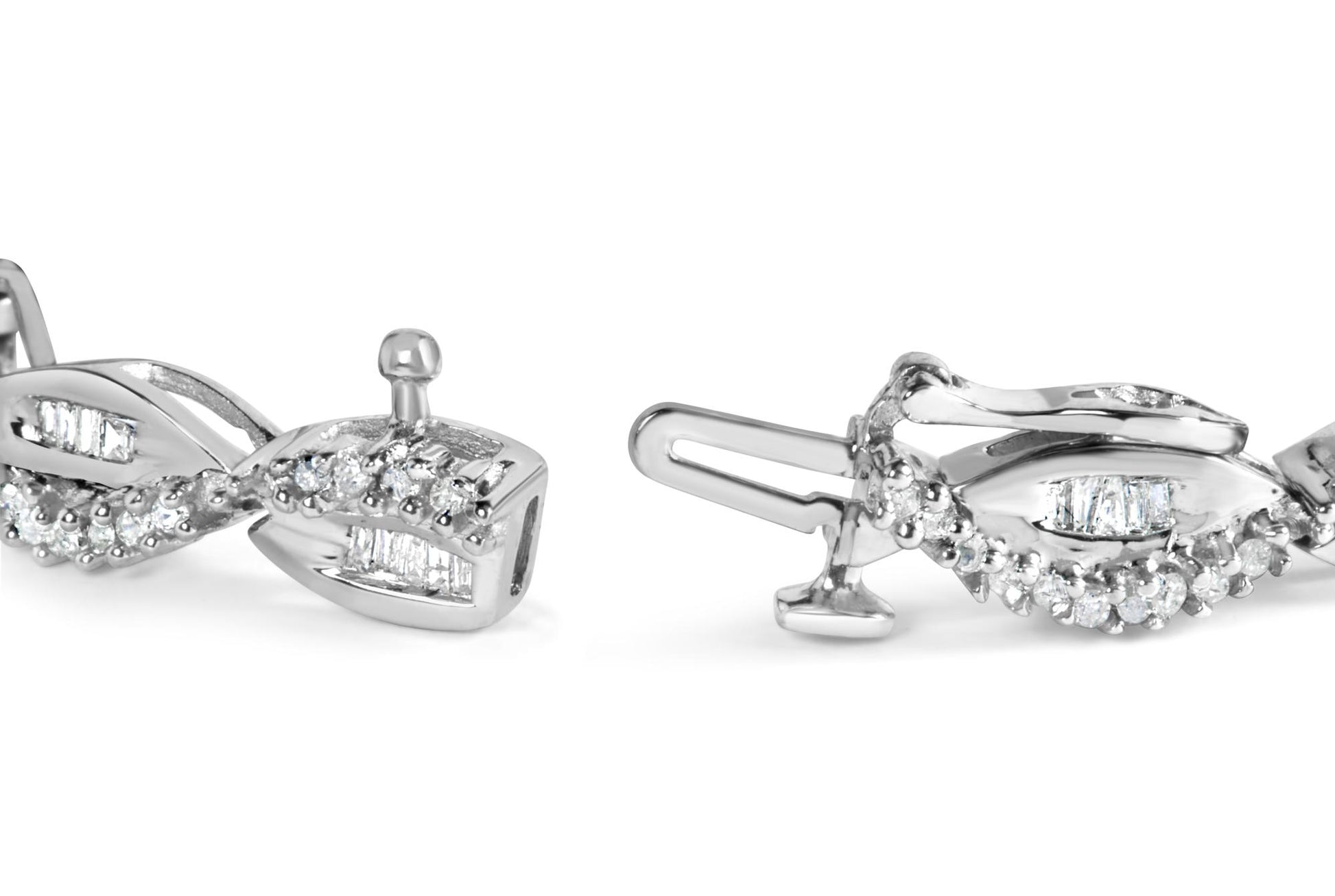 Close-up angled view of a white bracelet featuring round gemstones in prong settings and baguette gemstones in channel settings along a twisted design.