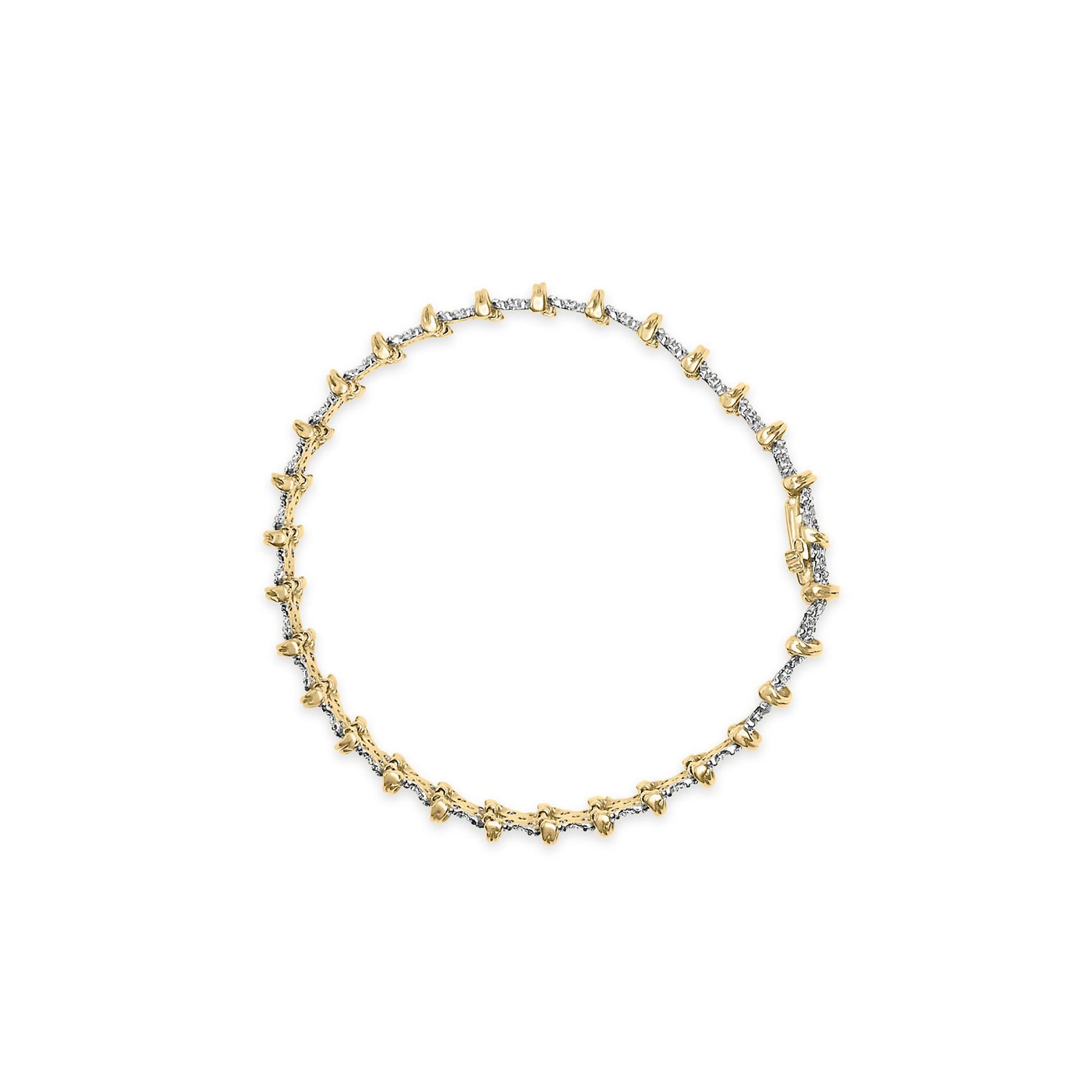 Top-down view of a yellow metal bracelet featuring a row of small round white gemstones in a pave setting.