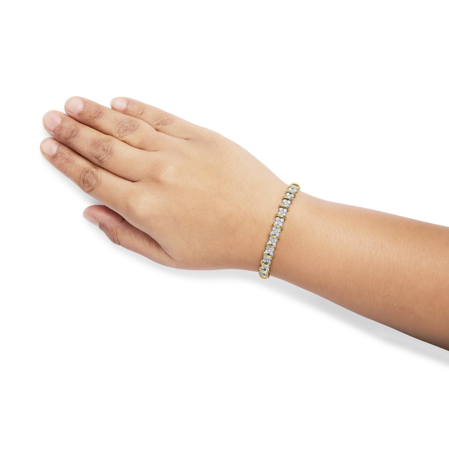 Yellow metal bracelet with white round gemstones in a pave setting, shown on a model's wrist from a top angle.