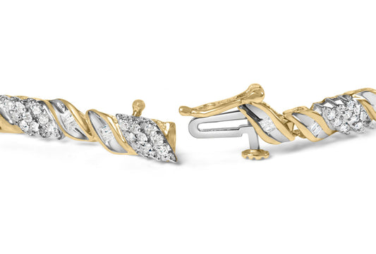 Close-up, front angle of a yellow bracelet with twisted design featuring round and baguette white gemstones in prong and channel settings.