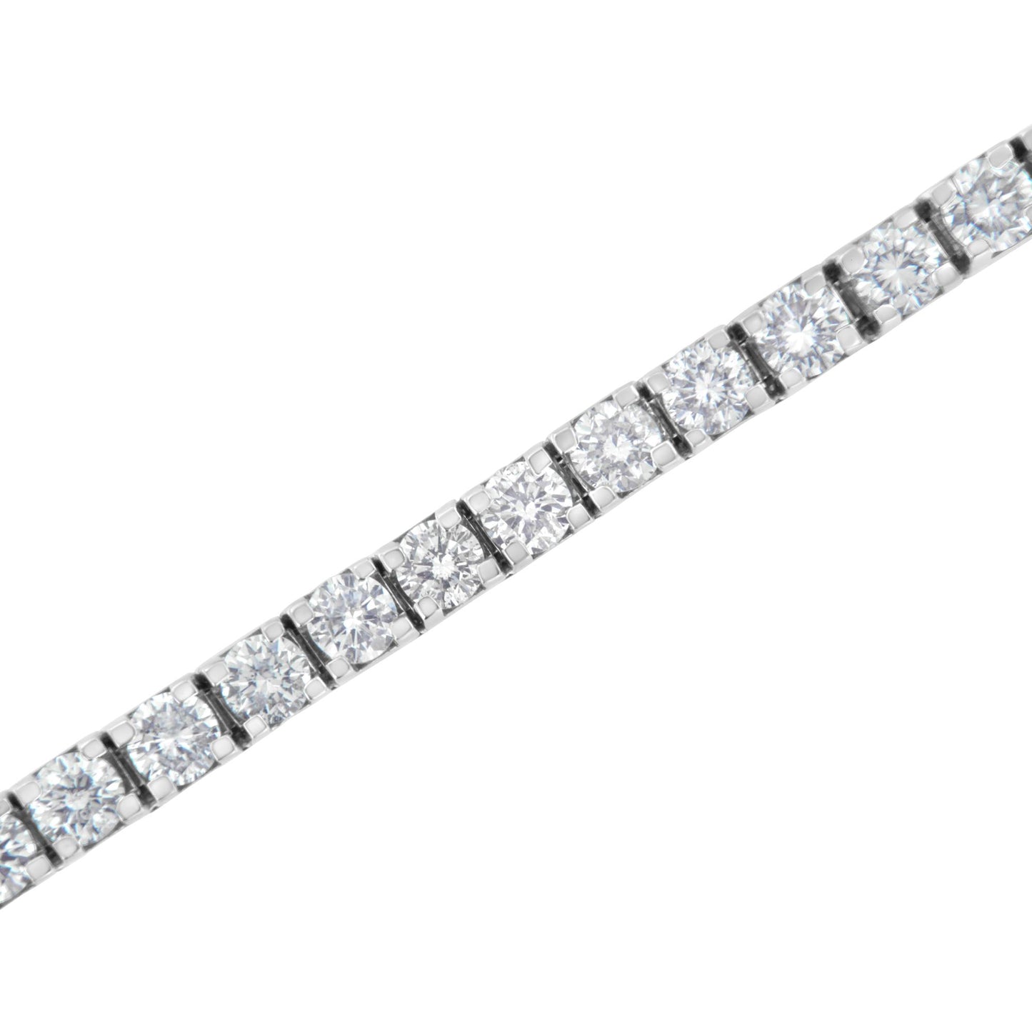 Close-up shot of a white metal bracelet with round white gemstones in prong settings arranged in a continuous line.