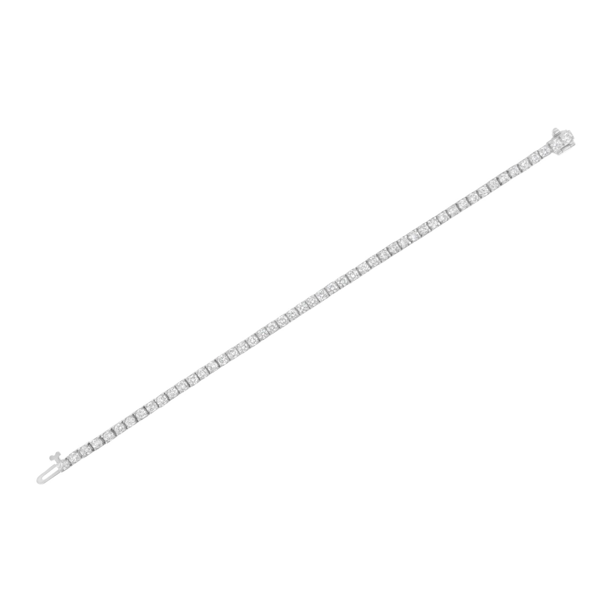 White metal bracelet with round white gemstones in prong settings, shown flat at a slight diagonal angle on a white background.