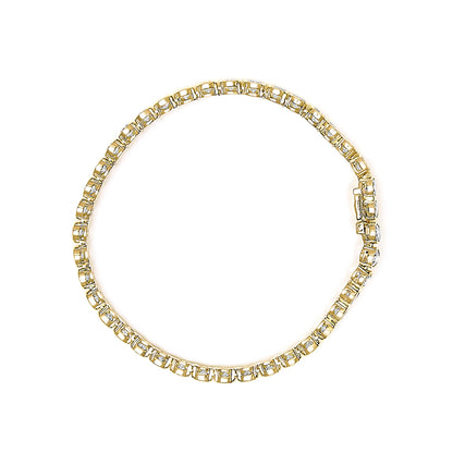 Close-up top view of a yellow bracelet with round white gemstones in bezel settings forming a continuous pattern.