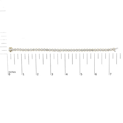 Yellow bracelet with round white gemstones in bezel settings, shown on a scale, front view.