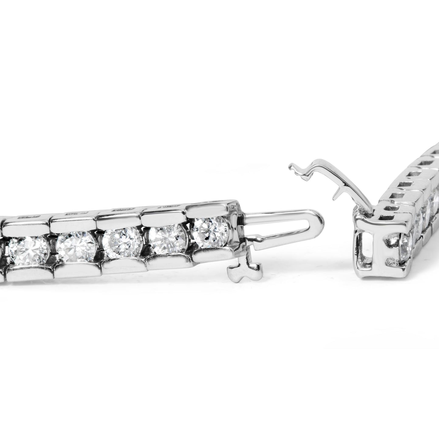 Close-up side angle of a white metal bracelet with round white gemstones in a channel setting, showing the open clasp mechanism.