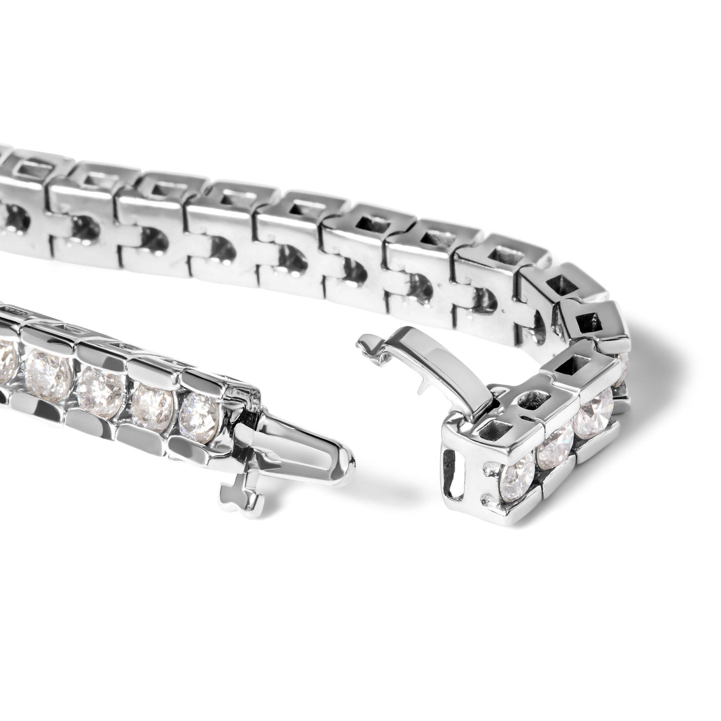 Close-up angled view of a white metal bracelet with round white gemstones in a channel setting, showing the clasp open.