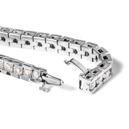 Close-up angled view of a white metal bracelet with round white gemstones in a channel setting, showing the clasp open.