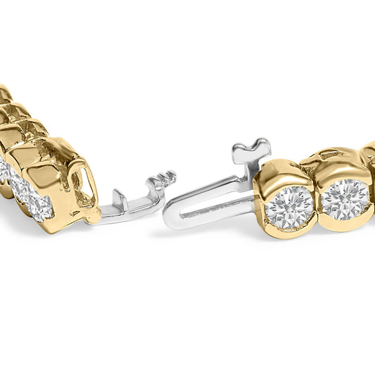 Close-up angled view of a yellow metal bracelet with round white gemstones in bezel settings, showing the clasp mechanism.